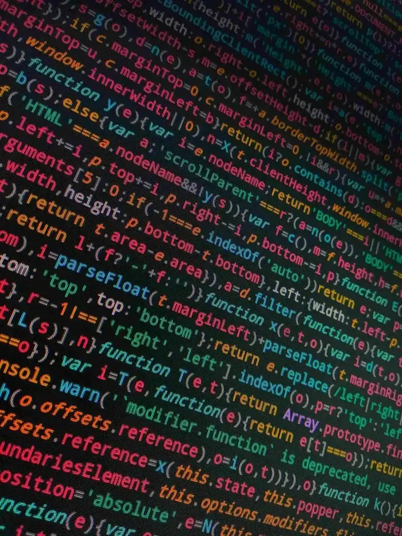 Close-up of colorful JavaScript code on a dark screen, illustrating the cost of writing software before defining the problem.